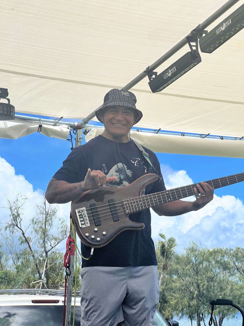 A bass player performing on the outdoor stage