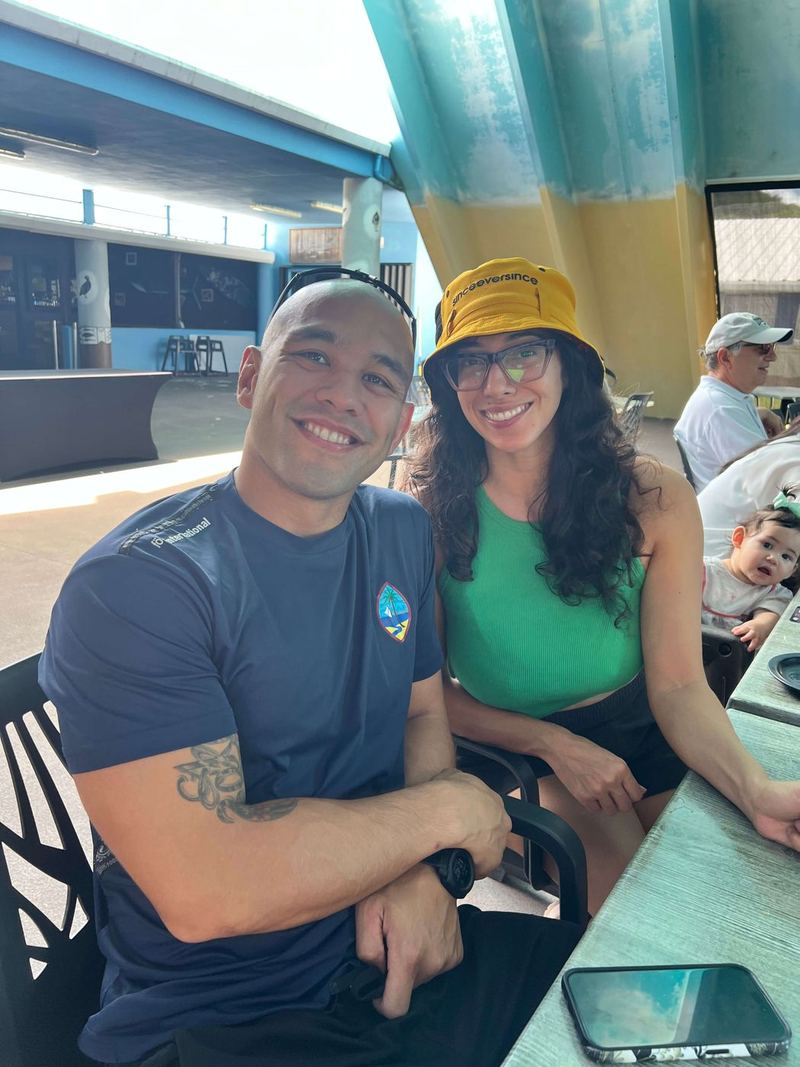 A smiling couple at a table in the pavilion