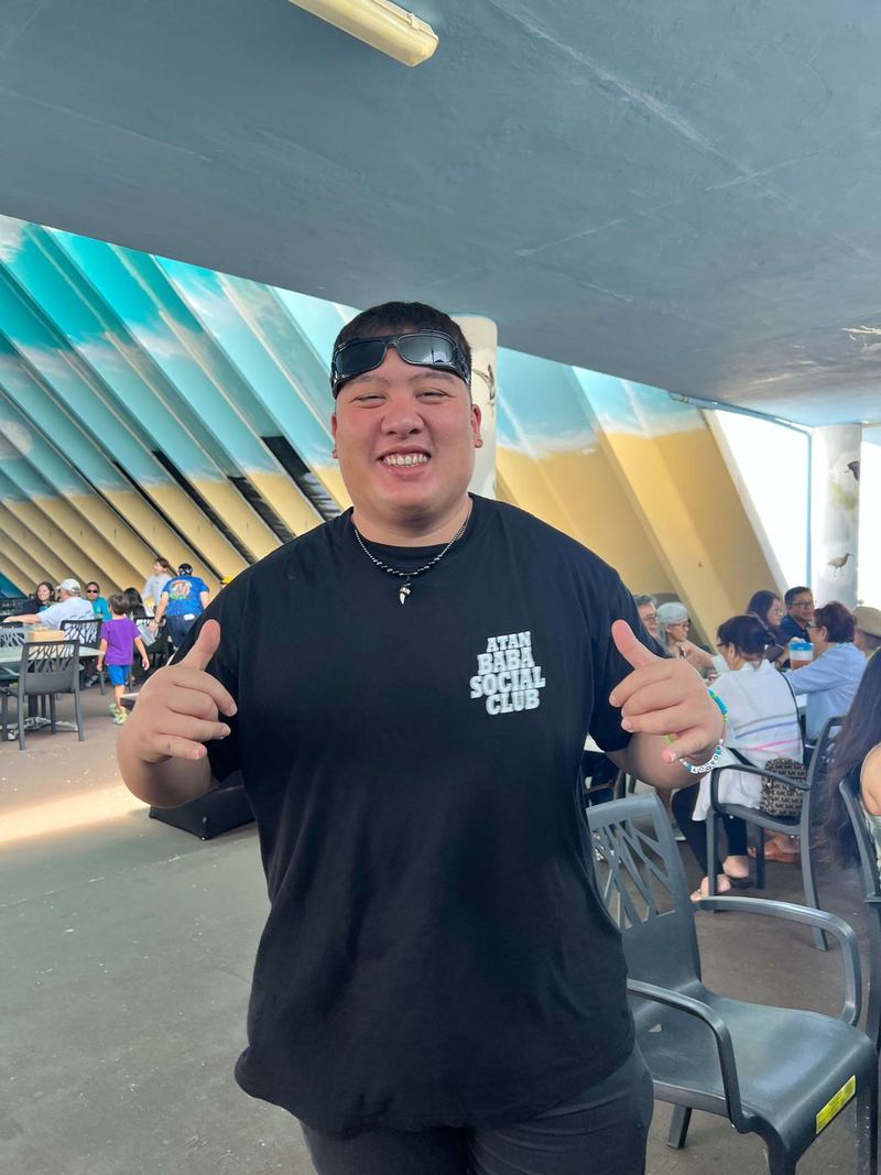 A visitor giving two thumbs up in the pavilion