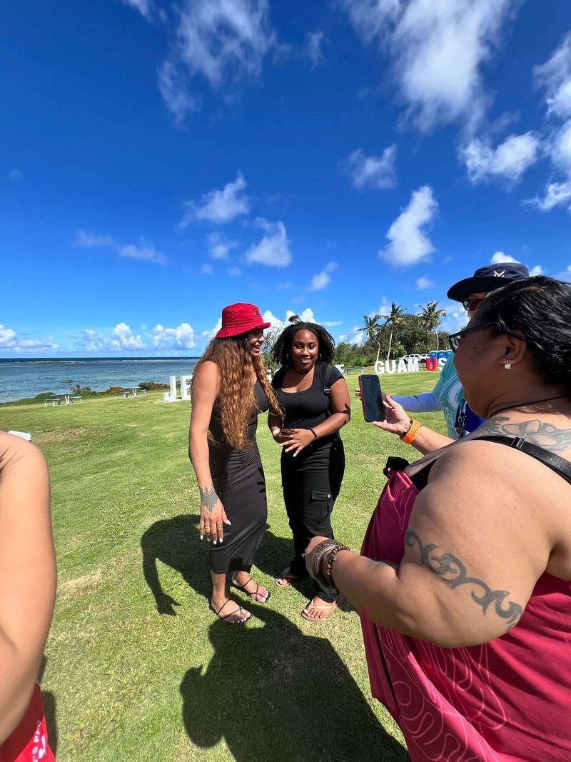 Guests on the oceanfront lawn, the Pacific and a wide blue sky behind them