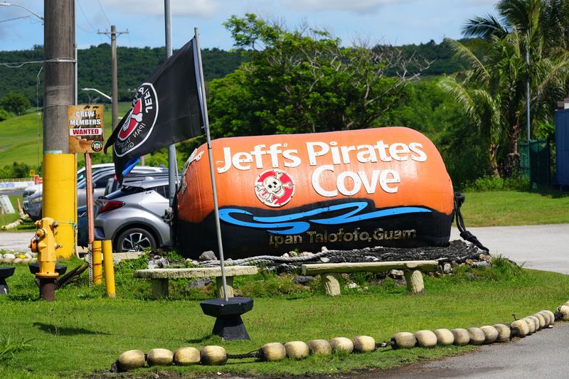 The orange boat-shaped Jeff's Pirates Cove sign flying a pirate flag beside Route 4