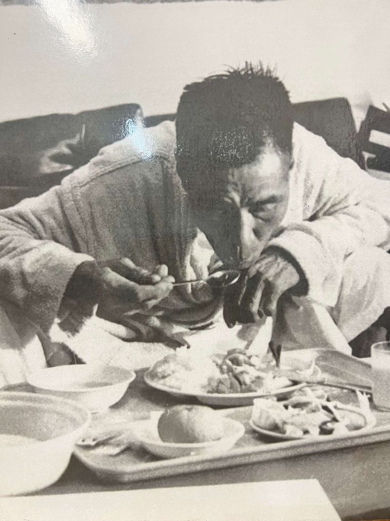 Shoichi Yokoi eating from a tray of food